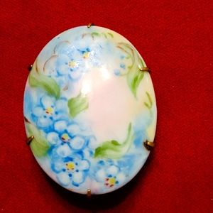 Antique painted ceramic flower brooch.